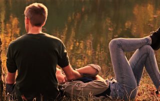 couple sitting in a field